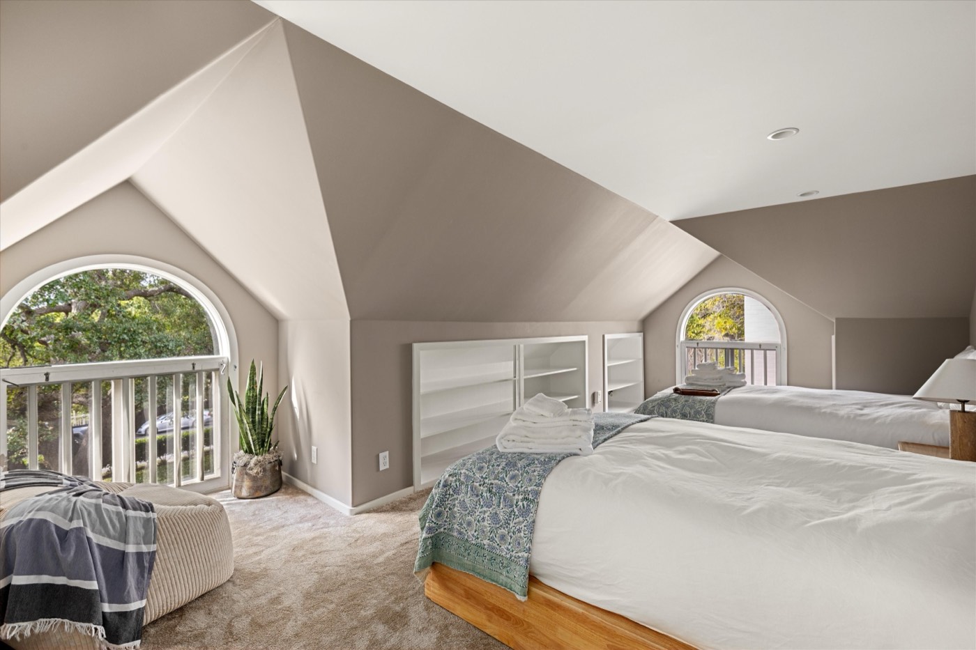 Attic bedroom with arched dormer windows